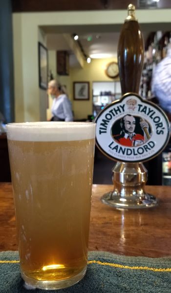 a pint of Timothy Taylor Landlord cask beer in an English pub